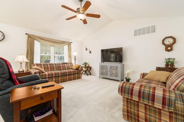living room featuring lofted ceiling, visible vents, a ceiling fan, and light colored carpet