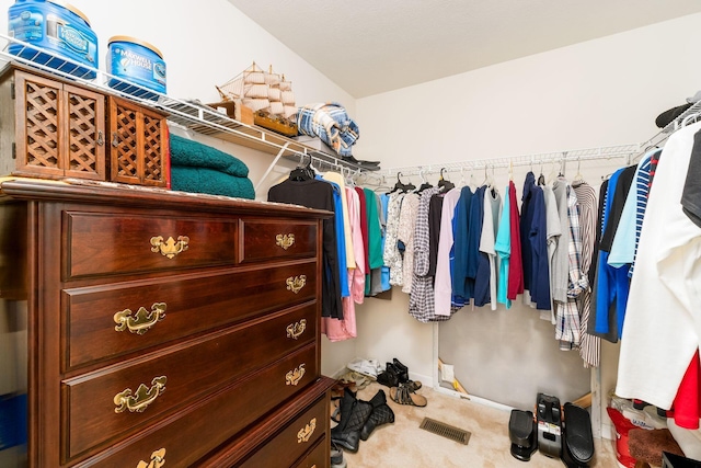 spacious closet featuring visible vents and carpet flooring