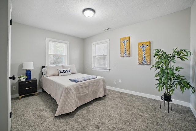 1425 Mount Vernon Ave, Columbus, OH 43203 - carpeted bedroom featuring a textured ceiling, visible vents, and baseboards
