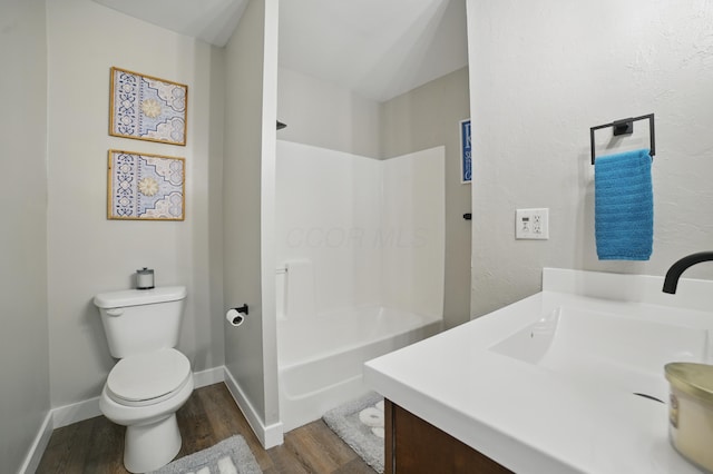 1425 Mount Vernon Ave, Columbus, OH 43203 - full bathroom with toilet, baseboards, shower / washtub combination, wood finished floors, and vanity
