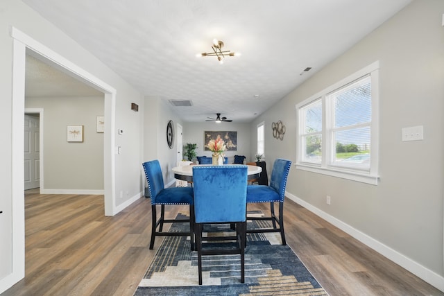 1425 Mount Vernon Ave, Columbus, OH 43203 - dining space featuring dark wood finished floors, visible vents, baseboards, and ceiling fan with notable chandelier
