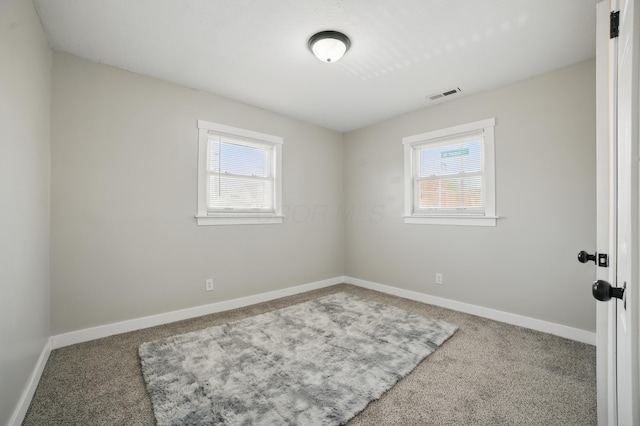 1425 Mount Vernon Ave, Columbus, OH 43203 - carpeted empty room featuring a wealth of natural light, visible vents, and baseboards