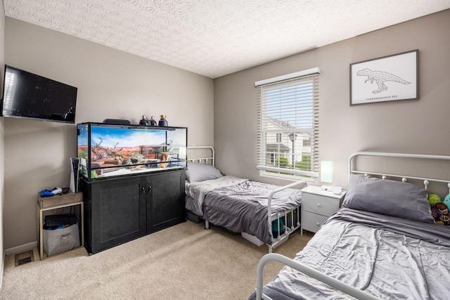 bedroom with a textured ceiling and light colored carpet