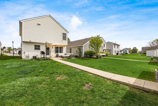 rear view of property with central air condition unit, a patio, an outdoor hangout area, a residential view, and a lawn
