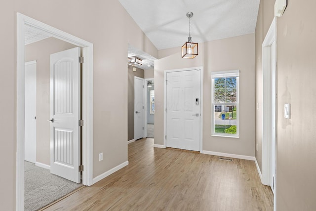 9222 Windy Creek Dr, Columbus, OH 43240 - foyer with baseboards, visible vents, and light wood-style flooring