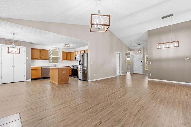 9222 Windy Creek Dr, Columbus, OH 43240 - unfurnished living room featuring baseboards, light wood-style floors, and a chandelier