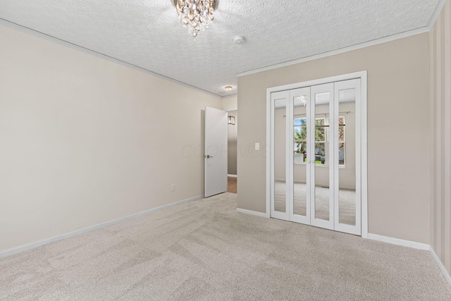 9222 Windy Creek Dr, Columbus, OH 43240 - carpeted spare room with baseboards, a textured ceiling, a chandelier, and ornamental molding