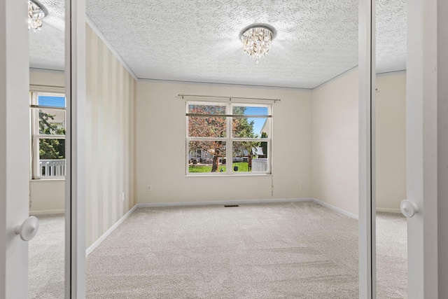 9222 Windy Creek Dr, Columbus, OH 43240 - carpeted empty room featuring a chandelier, a textured ceiling, and baseboards