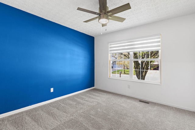 9222 Windy Creek Dr, Columbus, OH 43240 - empty room with visible vents, a ceiling fan, carpet floors, baseboards, and a textured ceiling