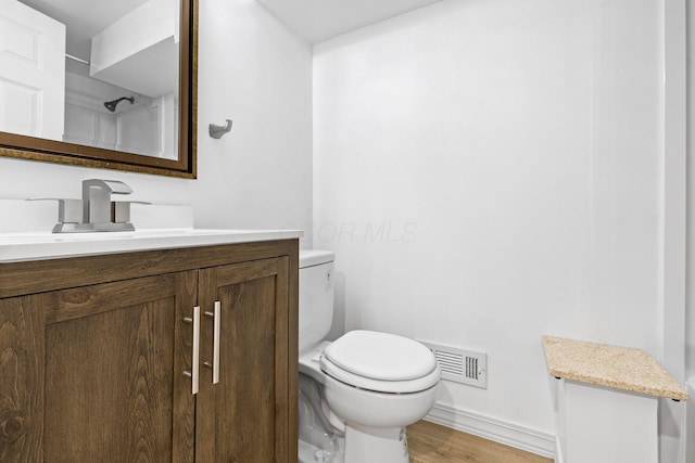 9222 Windy Creek Dr, Columbus, OH 43240 - bathroom with wood finished floors, visible vents, toilet, vanity, and baseboards