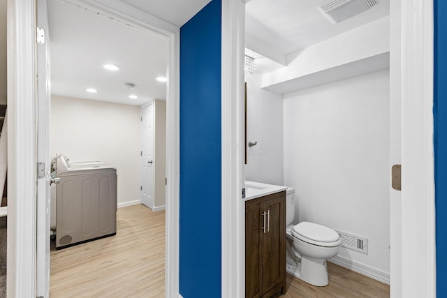 9222 Windy Creek Dr, Columbus, OH 43240 - half bathroom featuring recessed lighting, wood finished floors, visible vents, toilet, and washer / clothes dryer