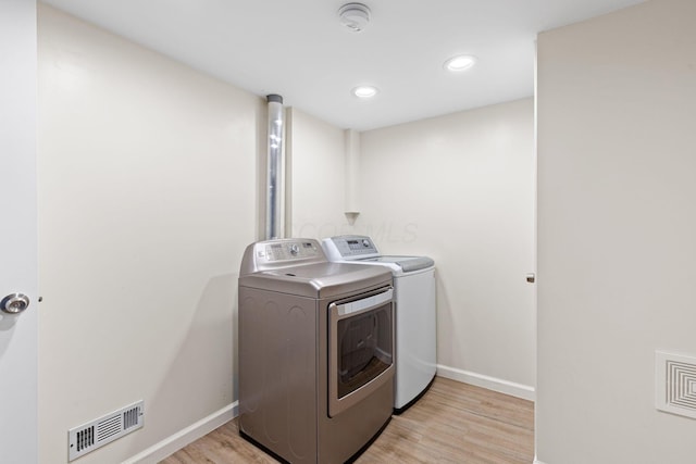 9222 Windy Creek Dr, Columbus, OH 43240 - clothes washing area with washing machine and dryer, baseboards, laundry area, and visible vents
