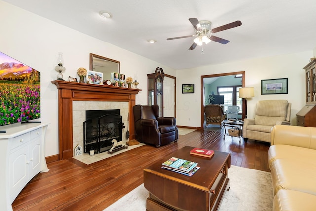 4690 Arrowhead Dr NW, Carroll, OH 43112 - living area featuring ceiling fan, hardwood / wood-style flooring, a tiled fireplace, and baseboards