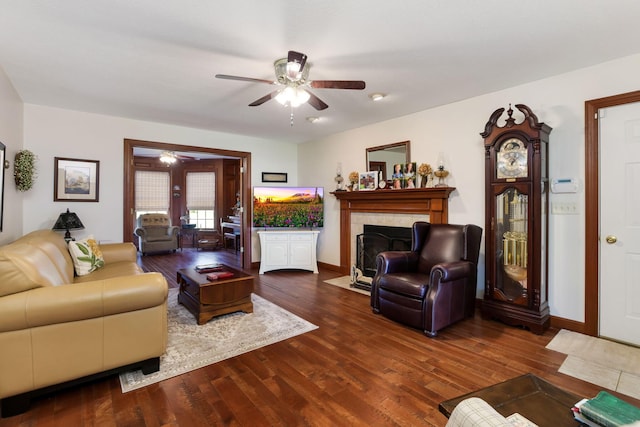 4690 Arrowhead Dr NW, Carroll, OH 43112 - living area with a ceiling fan, wood finished floors, a fireplace with flush hearth, and baseboards