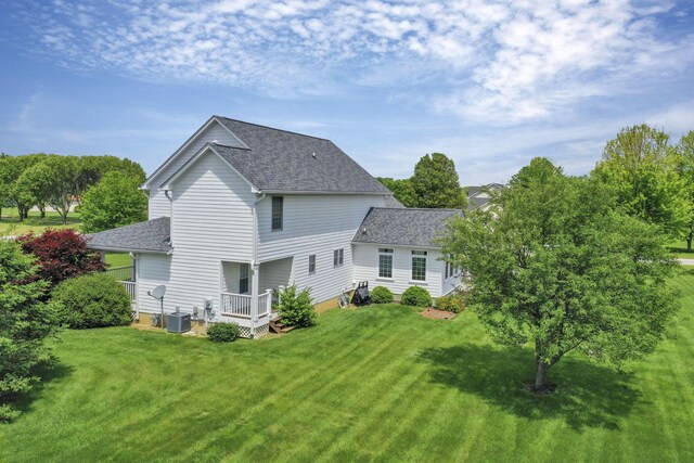 4690 Arrowhead Dr NW, Carroll, OH 43112 - back of property with a shingled roof, a lawn, central AC unit, and a deck