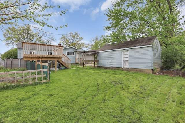 view of yard featuring fence, stairway, and a deck