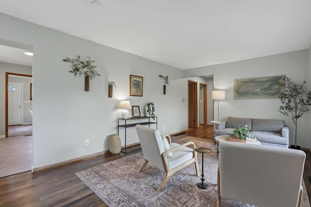 living room with baseboards and wood finished floors