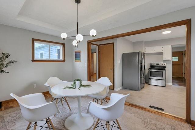 dining area featuring baseboards and visible vents