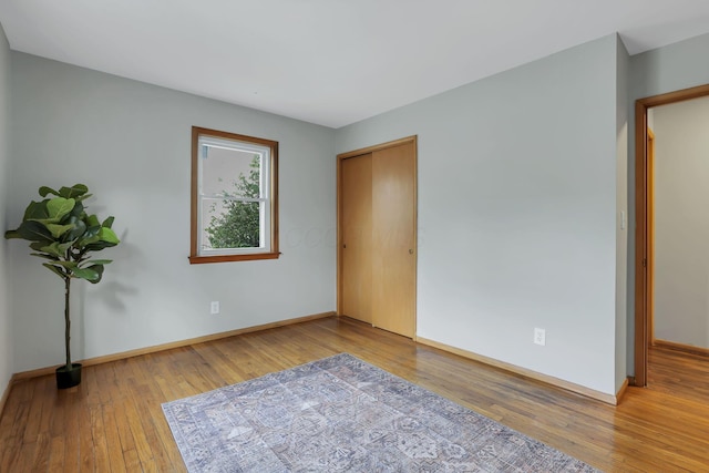 unfurnished bedroom featuring baseboards and wood-type flooring
