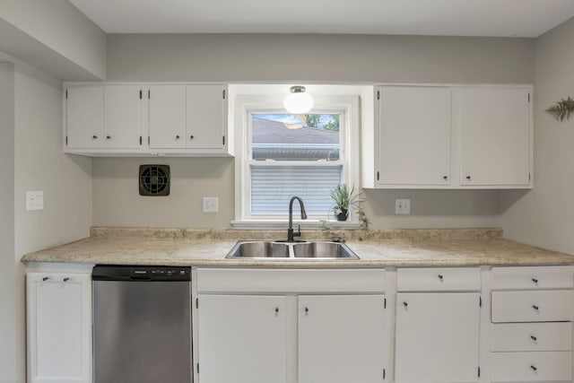 kitchen with stainless steel dishwasher, white cabinets, a sink, and light countertops