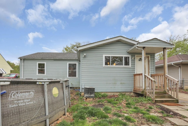 rear view of house featuring central AC