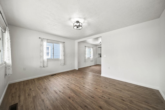 2728 Hiawatha St, Columbus, OH 43211 - spare room with wood finished floors, a textured ceiling, and baseboards