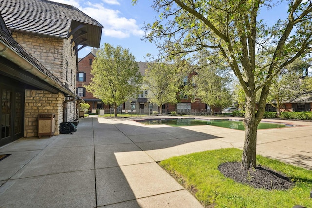 exterior space featuring an outdoor pool and a patio area