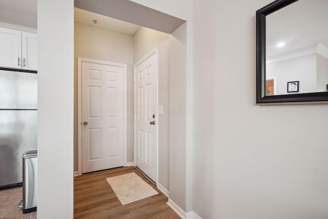 doorway to outside with baseboards and wood finished floors
