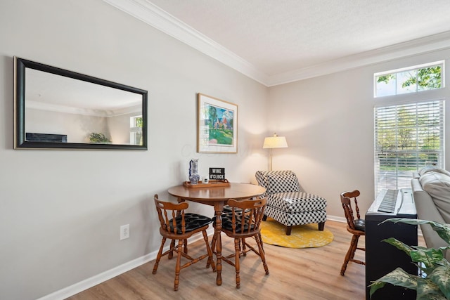 dining space with crown molding, wood finished floors, and a wealth of natural light