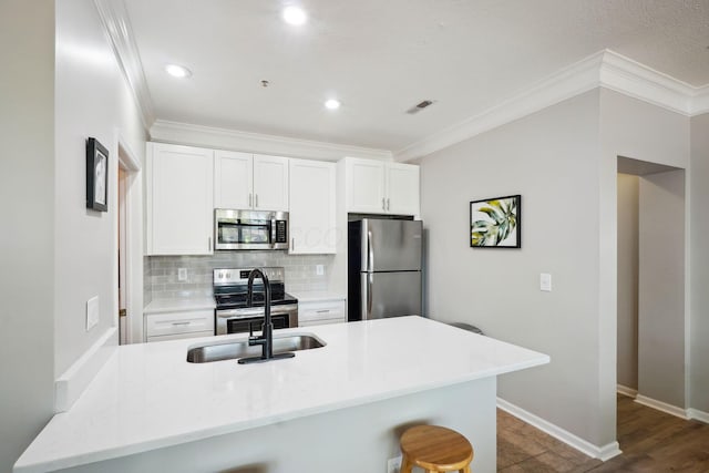 kitchen with crown molding, stainless steel appliances, and visible vents
