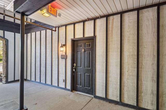 property entrance featuring board and batten siding