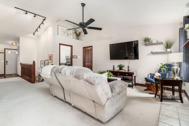 living area with baseboards, light colored carpet, lofted ceiling, a ceiling fan, and rail lighting