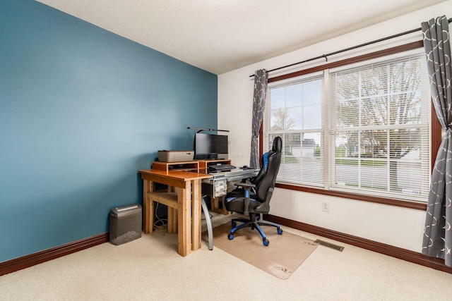 office with baseboards, visible vents, and carpet