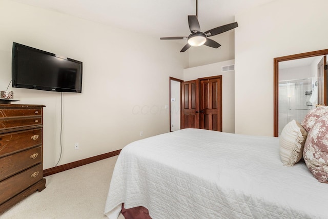 bedroom with visible vents, light carpet, connected bathroom, baseboards, and ceiling fan