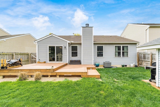 back of property featuring central AC, a chimney, a fenced backyard, a yard, and a wooden deck
