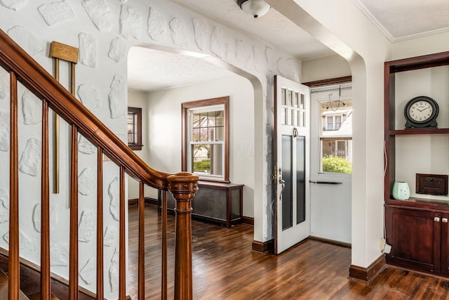 629 Hilltonia Ave, Columbus, OH 43223 - foyer featuring dark wood-style floors, arched walkways, baseboards, stairs, and ornamental molding