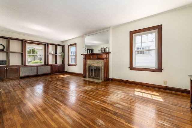 629 Hilltonia Ave, Columbus, OH 43223 - unfurnished living room with baseboards, ornamental molding, a brick fireplace, and hardwood / wood-style floors