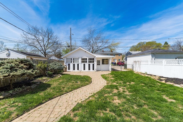 629 Hilltonia Ave, Columbus, OH 43223 - rear view of house featuring a lawn, a fenced backyard, and an outbuilding
