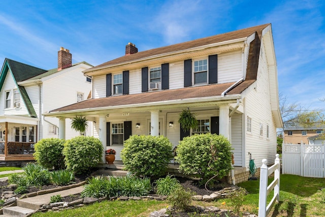 629 Hilltonia Ave, Columbus, OH 43223 - view of front of house with a chimney, covered porch, and fence