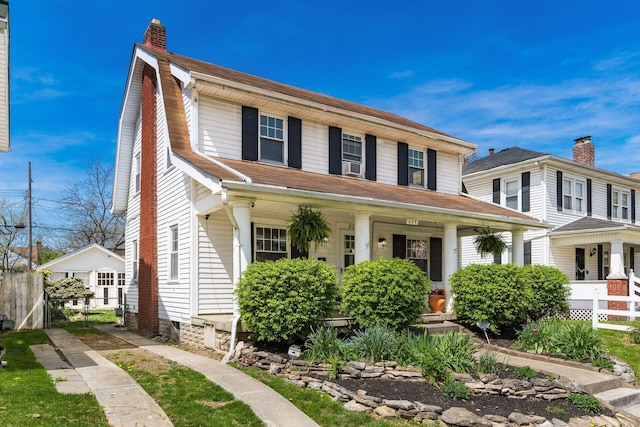 629 Hilltonia Ave, Columbus, OH 43223 - view of front facade featuring a chimney, fence, and covered porch
