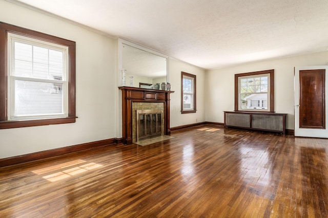 629 Hilltonia Ave, Columbus, OH 43223 - unfurnished living room featuring radiator, hardwood / wood-style floors, ornamental molding, baseboards, and a fireplace