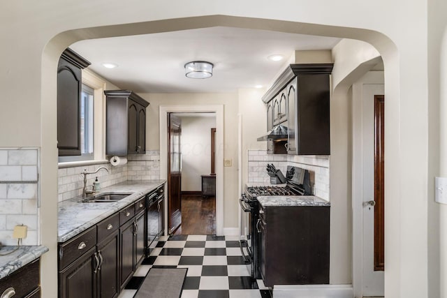 629 Hilltonia Ave, Columbus, OH 43223 - kitchen with dark floors, under cabinet range hood, a sink, arched walkways, and black appliances
