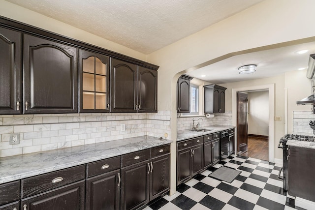 629 Hilltonia Ave, Columbus, OH 43223 - kitchen featuring a sink, gas stove, decorative backsplash, dark floors, and black dishwasher