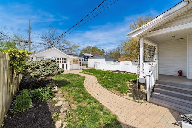629 Hilltonia Ave, Columbus, OH 43223 - view of yard with an outdoor structure, a porch, and a fenced backyard