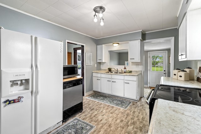 kitchen with crown molding, light countertops, white cabinetry, a sink, and stainless steel appliances