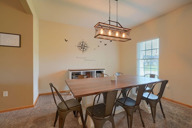 dining room featuring carpet floors and baseboards