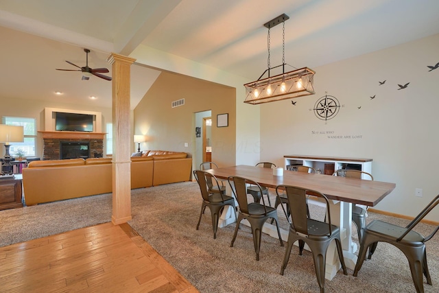 dining area featuring vaulted ceiling with beams, decorative columns, ceiling fan, light wood finished floors, and visible vents