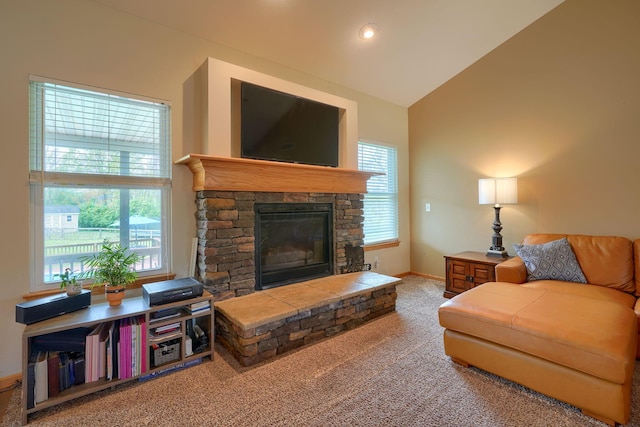 living area with baseboards, high vaulted ceiling, a stone fireplace, and carpet floors
