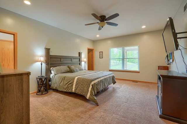 bedroom featuring visible vents, light carpet, and baseboards