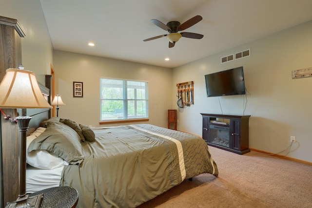 carpeted bedroom with recessed lighting, a fireplace, baseboards, visible vents, and a ceiling fan